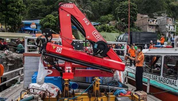 Members of the Indonesian rescue team prepare to deploy sonar equipment to help search for missing passengers at the Lake Toba ferry port on Friday.
