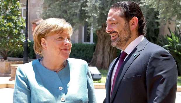 German Chancellor Angela Merkel (L) shakes hands with Lebanese Prime Minister Saad Hariri at the Lebanese government office in Beirut.