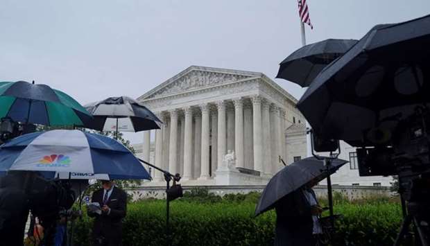 Television reporters wait prior to the US Supreme Court's decision to impose limits on the ability of police to obtain cellphone data pinpointing the past location of criminal suspects, outside the US Supreme Court in Washington.