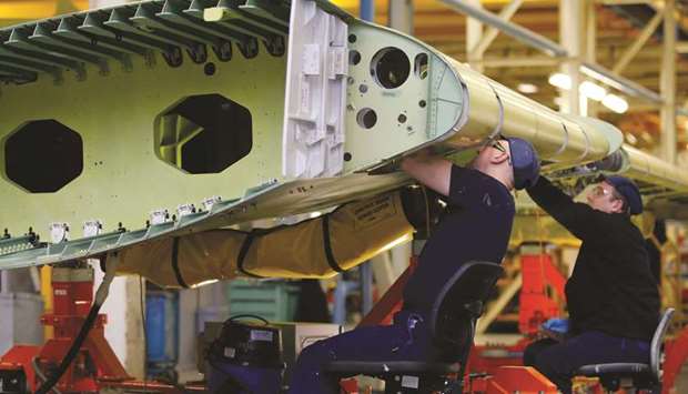 Employees work on a section of Airbus A320 wing inside the Airbus Group assembly plant in Broughton, UK. Airbus said current plans for a transition period ending in December 2020 were too short for the European plane maker to adapt its supply chain and would prevent it from expanding its British supplier base.