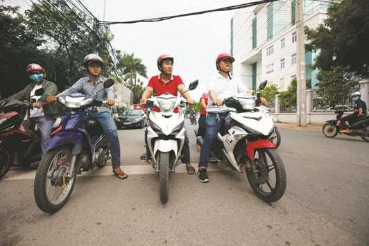 u201cStreet knightu201d Nguyen Thanh Hai, right, and his team ride as they patrol on a street in Thu Dau Mot city.
