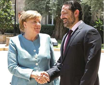 German Chancellor Angela Merkel shakes hands with Lebanese Prime Minister Saad al-Hariri at the government office in Beirut, during her official visit, yesterday.
