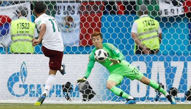 Mexico's Carlos Vela scores their first goal from a penalty past South Korea's Cho Hyun-woo