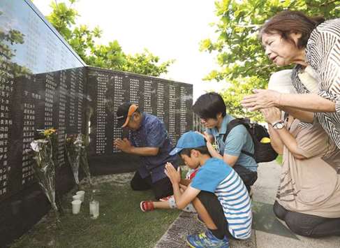 Relatives of war victims pray at the Itoman Peace Memorial park in Itoman City, Okinawa prefecture, yesterday.