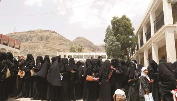 Women displaced by the fighting in the Red Sea port city of Hodeidah queue to register in a school allocated for IDPs in Sanaa, yesterday.