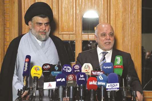 Iraqi Prime Minister Haider al-Abadi attends a press conference with Iraqi cleric and leader Moqtada al-Sadr in Najaf, yesterday.