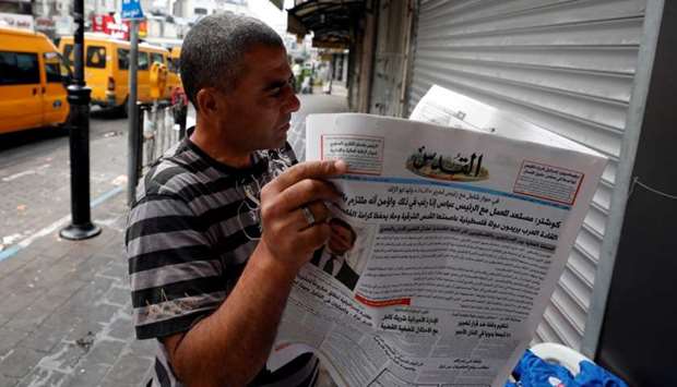 A man reads the Palestinian newspaper Al Quds that published an interview with Jared Kushner, US President Donald Trump's senior adviser, in Ramallah in the occupied West Bank.