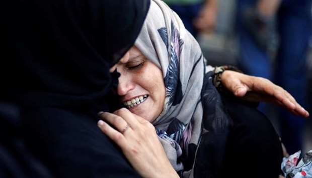 A relative mourns during the funeral of Osama Abu Khater.