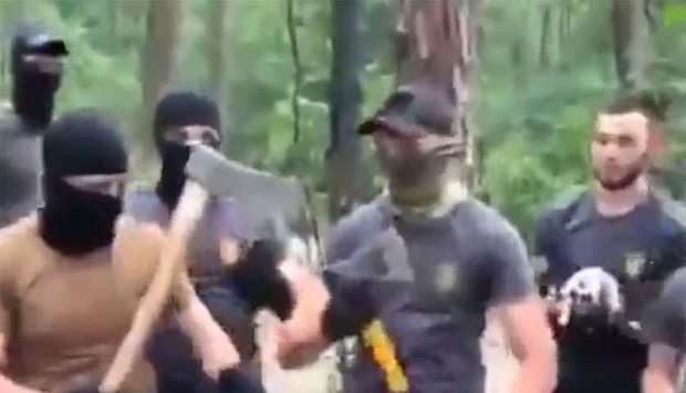 Masked attackers wielding their weapon. The video from which this screen shot taken was posted by the assailants themselves on social media.