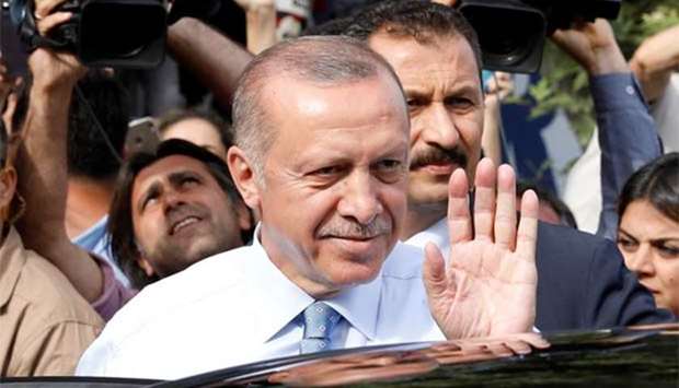 Turkish President Recep Tayyip Erdogan waves to supporters as he leaves his residence in Istanbul on Sunday.
