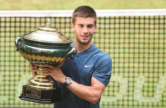 Borna Coric from Croatia poses with his trophy after defeating Roger Federer of Switzerland in the final of the ATP Halle tournament yesterday. (AFP)