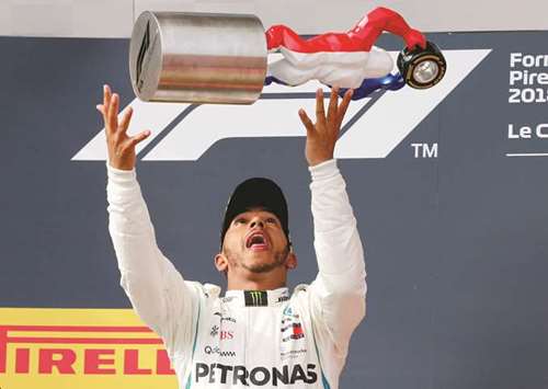 Mercedesu2019 Lewis Hamilton celebrates with the trophy on the podium after winning the French GP yesterday. (Reuters)