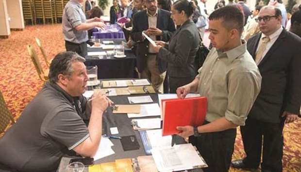 A recruiter talks talks to a job seeker at a career fair in New York. A strong non-farm payrolls report in May showed well over 200,000 jobs generated.  File picture