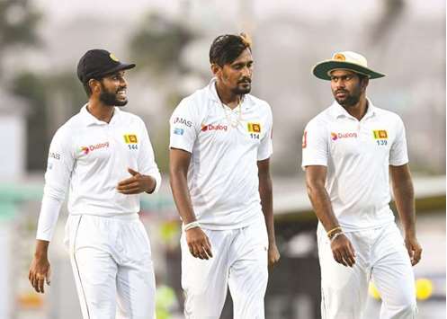 Roshen Silva (left), Suranga Lakmal (centre) and Lahiru Kumara of Sri Lanka confer during Day 1 of the 3rd Test against West Indies at Kensington Oval, Bridgetown, Barbados. (AFP)