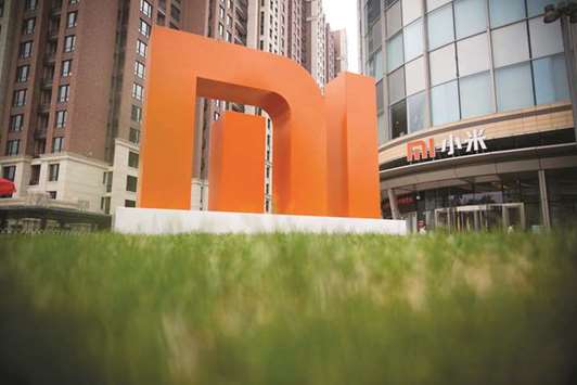The Xiaomi Corp logo is displayed outside the companyu2019s headquarters in Beijing. Xiaomiu2019s decision to postpone the China half of its stock debut is a setback to the nationu2019s plan to compete with Hong Kong and New York for the worldu2019s biggest initial public offerings.