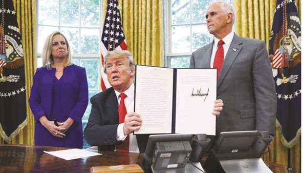 Trump with US Department of Homeland Security Secretary Kirstjen Nielsen and Vice-President Mike Pence.