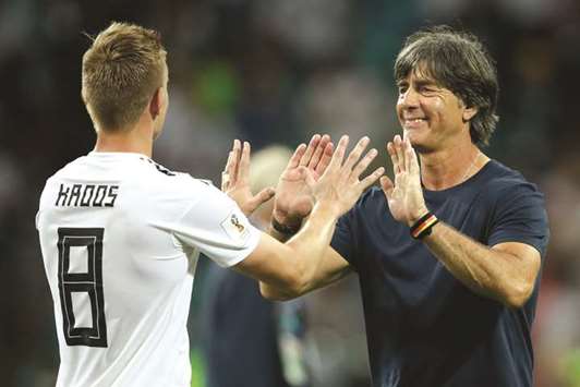 Germanyu2019s midfielder Toni Kroos (L) is congratulated by coach Joachim Loew in Sochi on Saturday.