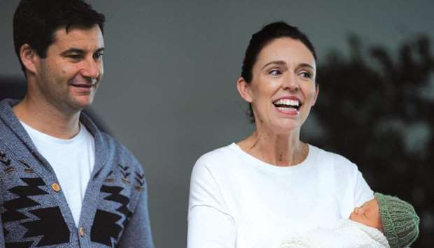Jacinda Ardern carries her newborn baby Neve Te Aroha Ardern Gayford with her partner Clarke Gayford as she walks out of the Auckland Hospital in New Zealand, yesterday.