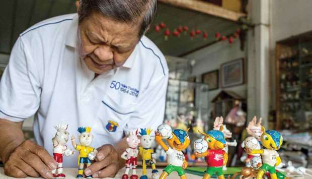 Nguyen Thanh Tam displaying various Football World Cup mascots including Fuleco (front R), the 2014 Brazil World Cup mascot, at his home in Ho Chi Minh City.