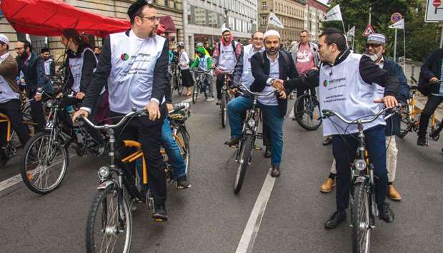 Jews and Muslims, one person of each faith sharing a tandem bicycle, are seen at the start of the u2018Meet2respectu2019 bicycle demonstration in Berlin yesterday.