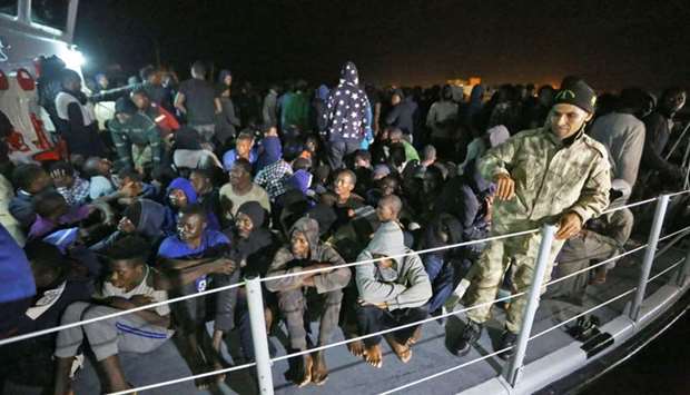 Migrants arrive at a naval base in Tripoli yesterday, after being rescued in the Mediterranean.