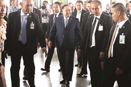 Thailandu2019s Deputy Prime Minister and Defence Minister Prawit Wongsuwan, centre, arrives at a meeting with political parties in Bangkok yesterday.