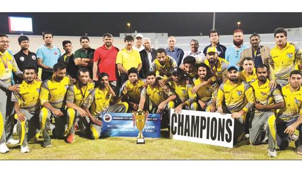 Warriors Club players pose with trophy after winning the u2018Au2019 Division title of the Ramadan Cup Twenty20 Cricket Tournament.