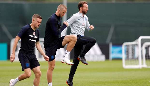 England players Jamie Vardy (left), Eric Dier (centre) and manager Gareth Southgate warm up during a training session in Saint Petersburg yesterday. (Reuters)