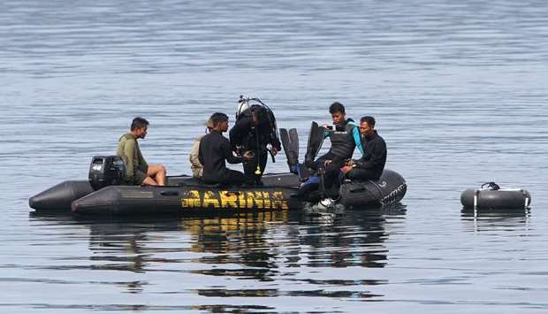 Divers conduct search and retrival operations in Lake Toba yesterday.