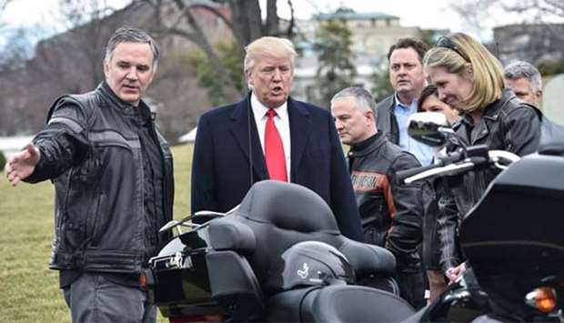 US President Donald Trump speaks with Harley Davidson CEO Matthew Levatich (left) as he greets Harley Davidson executives and union representatives at the White House in Washington, DC, in February 2017. File picture