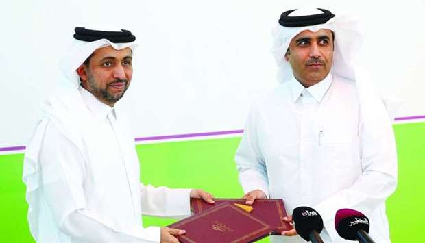 QU president Dr Hassan al-Derham and Kahramaa president Issa bin Hilal al-Kuwari exchange document after signing an MoU. PICTURE: Jayaram