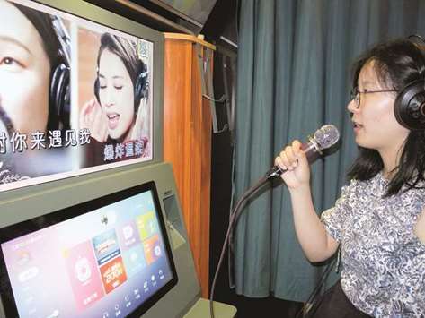 SINGER: A woman sings in a karaoke booth in Beijing.