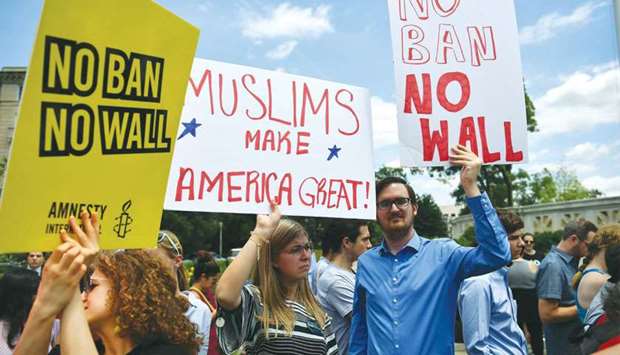 People protest the Muslim travel ban outside the US Supreme Court in Washington yesterday.