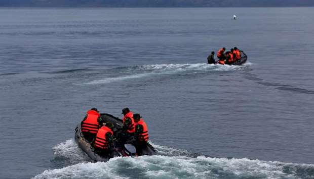 Rescue team members use rubber boats during a search operation for missing passengers after a ferry sank earlier this week in Lake Toba in Simalungun, North Sumatra.