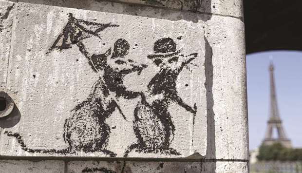 A recent artwork by street artist Banksy in Paris near the Eiffel Tower.
