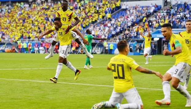 Colombia's defender Yerry Mina (L) celebrates with teammates after scoring a goal during the Russia 2018 World Cup Group H football match against Senegal