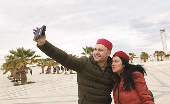 British tourists takes a selfie after arriving to Tunisia at the Enfidha Airport (file). The North African nation is struggling to revive a crippled economy as unemployment hovers around 15% and spending cuts bite.