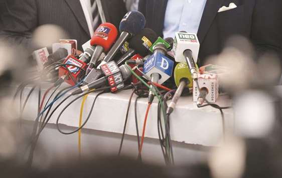 In this picture taken on June 28, microphones of the different Pakistani news channels are seen on a desk before a news conference outside the Supreme Court building in Islamabad.