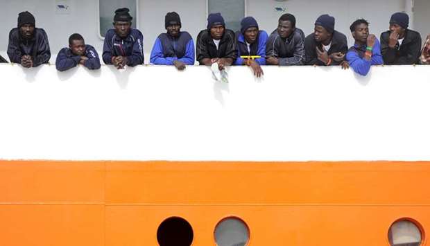 Migrants wait to disembark from Aquarius in the Sicilian harbour of Catania, Italy, on May 27, 2018