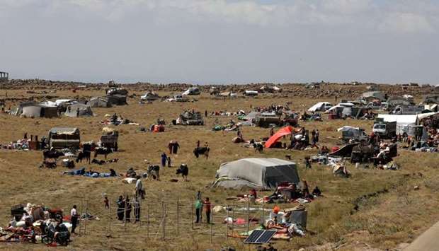 Internally displaced people from Deraa province are gathered near Golan Heights in Quneitra