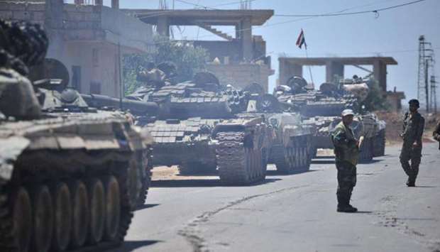 Forces loyal to Syria's President Bashar al-Assad are deployed in al-Ghariya al-Gharbiya in Deraa province, Syria.