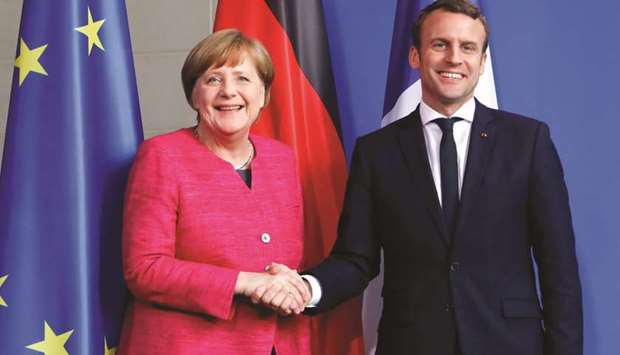 German Chancellor Angela Merkel and French President Emmanuel Macron shake hands after a news conference at the Chancellery in Berlin, Germany, on May 15, 2017.  The Meseberg Summit between Chancellor Merkel and Macron delivered an agreement on eurozone reform.