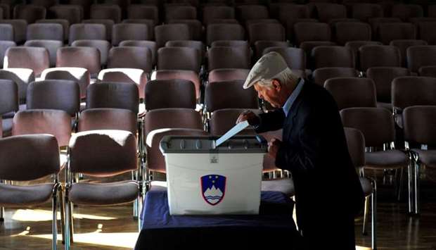 A man casts his vote at a polling station during the general election in Vodice, Slovenia