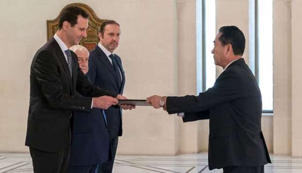 President Bashar al-Assad (L) receiving diplomatic credentials from North Korea's newly-appointed ambassador to Damascus (R), Mun Jong-nam, in the Syrian capital on May 30, 2018.