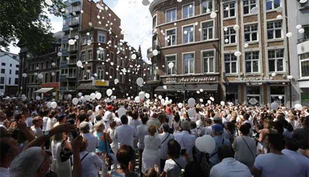 People take part in a white march to commemorate the victims of a shooting in Liege, at the Tivoli space, in Liege city centre on Sunday.