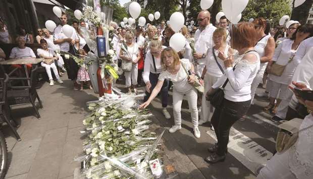People take part in the march yesterday to commemorate the victims of the May 29 shooting in Liege.