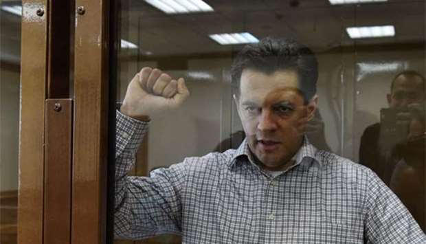 Journalist Roman Sushchenko, who worked for Ukrainian state news agency Ukrinform for over a decade, gestures in the court in Moscow on Monday.