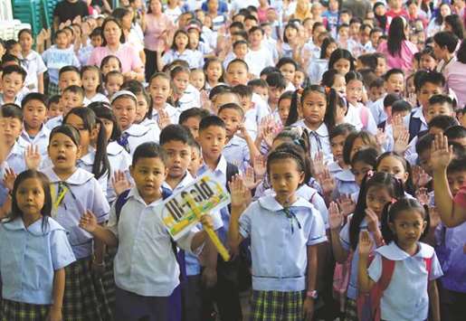 Pupils recite u201cPanatang Makabayanu201d, an oath of allegiance to the country, during the opening of classes at a Baclaran Elementary School Unit 1 in Paranaque city, Metro Manila, yesterday.