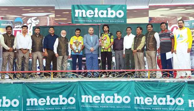 Captains of winners Hanan XII and runners-up CCRC pose with their respective trophies, Gulf Inconu2019s Senior Sales and Marketing Manager Sajjad Ahmed Khan, Qatar Veterans Cricket officials and other dignitaries during the prize distribution ceremony for Division I of 24th Gulf Incon-Metabo Ramadan Cricket Tournament 2018 at old Ideal Indian School Floodlit Cricket Grounds.