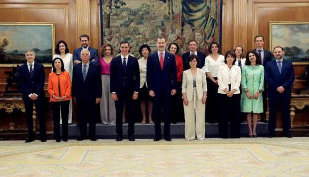Spain's new cabinet members stand with King Felipe during a swearing-in ceremony at the Zarzuela Palace outside Madrid